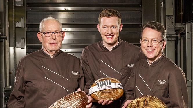 Herbert Wortmann, Christian und Hans-Joachim Scherpel halten Malzers Brote in den Händen